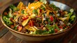 A colorful taco salad with seasoned beef, lettuce, tomatoes, cheese, and crunchy tortilla strips