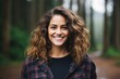 © Balaraw - Smiling woman with curly hair in a forest