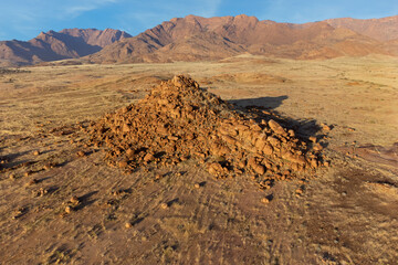 Wall Mural - Scenic desert landscape with rocks and arid grassland, Brandberg mountain, Namibia.