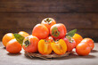 fresh persimmon fruit on a wooden background
