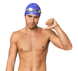 Young Hispanic man with swim gear showing thumb down, disappointment concept.