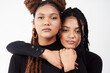 © peopleimages.com - Love, portrait or serious black woman with sister in studio on white background for natural beauty. Braids, face and hug with confident sibling people together for cosmetics, support or friends