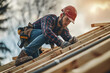 © Fabio - male roofer carpenter working on roof structure on construction site