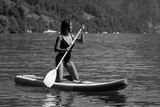Fototapeta Panele - Sexy woman paddling on paddleboard. Healthy summer lifestyle. Summer sport. SUP surfing tour in adventure summer vacation. Female fit model swimming with paddle board.