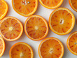 Fresh orange slices on white background. Vivid orange slices neatly arranged on a clean white surface, creating a bright and refreshing citrus pattern top view