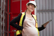 Portrait Happy caucasian logistic engineer pregnant woman working at container site	