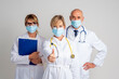 Group of healthcare worker wearinc surgical mask and standing together and isolated background