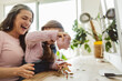 © Westend61 - Granddaughter holding piggy bank over coins with grandmother at home