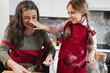 © Westend61 - Playful grandmother and granddaughter cooking together in kitchen at home