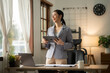 © Thitisak - ฺAsia Businesswoman sitting and working using laptop to chat with customers online in office