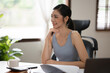 © Thitisak - ฺAsia Businesswoman sitting and working using laptop to chat with customers online in office