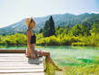 Travel, Freedom, Lifestyle concept. Young woman enjoying green nature outdoors. Amazing view on Zelenci (into English means - green) natural reserve in Slovenia, Europe. People in nature background.