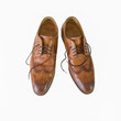 Pair of classic brown leather shoes on a white background isolated
