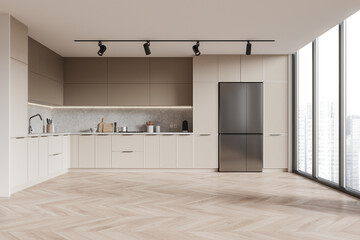 Wall Mural - A sleek modern kitchen interior with a herringbone floor, beige cabinetry, and daylight coming from large windows. 3D Rendering