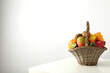 Set of tropical fruits in basket on white background, space for text
