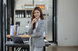 © SOMKID - Portrait of young business woman holding digital tablet in company office.