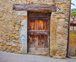 Old wooden door and shabby wall in Savosa village, Switzerland