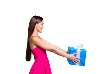 Poster - Side profile view of young straight-haired sweet tender brunette smiling girl with long hair, wearing pink dress, giving blue box with white ribbon. Isolated over bright vivid turquoise background