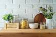 Kitchen table with food jars and plants over white brick wall  background.  Kitchen mock up for design and product display.