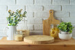 Empty wooden log  on kitchen table with food jars and plants over white brick wall  background.  Kitchen mock up for design and product display.