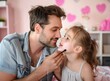 © Kiran - portrait of A dad will do anything to keep her smiling. A little girl and her dad putting makeup on her face while playing together at home.