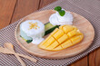 Sticky rice with mango on wood table
