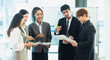 © SOMKID - Asian group of people working with documents have financial or marketing charts on a board room at a business presentation or seminar.
