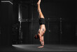 © Halfpoint - Rear view of handstand exercise, handstand push-ups. Routine workout for physical and mental health.
