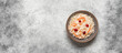 Sauerkraut with cranberries and carrots in a bowl on grunge background. Top view, flat lay, copy space. Banner