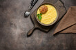Mashed potatoes with cutlet in a bowl on a wooden board, dark rustic background. Top view, flat lay