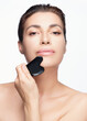 Beautiful Woman Using Gua Sha Stone for Facial Skincare. Beauty Skin care and Beauty concept