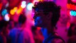 A young man in sunglasses is immersed in vibrant neon lights, encapsulating the dynamic energy of city nightlife.