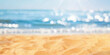 Blurred defocused natural background of tropical summer beach with sparkling reflections on the water. Summer vacation concept.