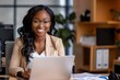 © Danko - Young smiling african american businesswoman using computer at the office