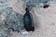 Bottle Found Discarded on a Beach in the Sand