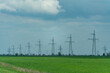 © svetograph - High voltage towers with sky background. Power line support with wires for electricity transmission. High voltage grid tower with wire cable at distribution station. Energy industry, energy saving