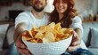 a couple in love is eating chips. selective focus