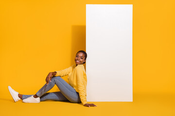 Wall Mural - Profile side view portrait of attractive cheerful girl sitting board copy empty space isolated on bright yellow color background