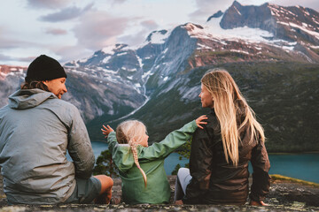 Wall Mural - Family vacations outdoor travel lifestyle adventure trip in Norway mother, father and child hiking together healthy lifestyle parents man and woman with kid daughter eco tourism in mountains