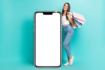 Sticker - Full length photo of pretty cute lady wear white blouse holding bargains modern device empty space isolated turquoise color background