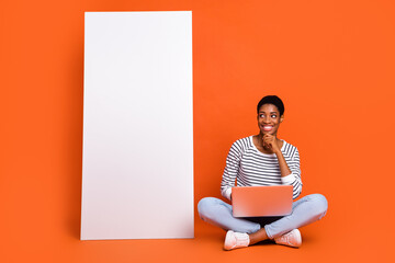 Wall Mural - Photo of thoughtful third gender person wear pullover chatting modern device empty space isolated orange color background