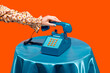 © VISTA by Westend61 - Woman picking up telephone receiver on table against orange background