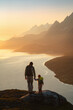 © EVERST - Family father and child hiking in mountains traveling together exploring Norway adventure healthy lifestyle outdoor active summer vacations dad with daughter with backpack enjoying sunset fjord view