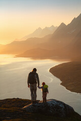 Wall Mural - family father and child hiking in mountains traveling together exploring norway adventure healthy li