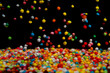 Colorful Candies in Mid-Air Against a Black Background