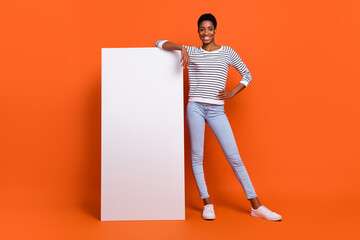 Wall Mural - Photo of shiny pretty third gender person wear pullover modern device empty space isolated orange color background