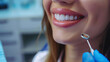 Beautiful snow-white smile of a young beautiful woman in a dental office