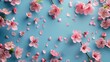 Sakura Flowers with Fallen Petals on Blue Background: Spring Floral Background