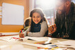 © Jacob Lund - Happy little girl looking at the camera in an art and drawing class