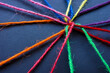 Connected colored threads as a concept of unity, teamwork and diversity.